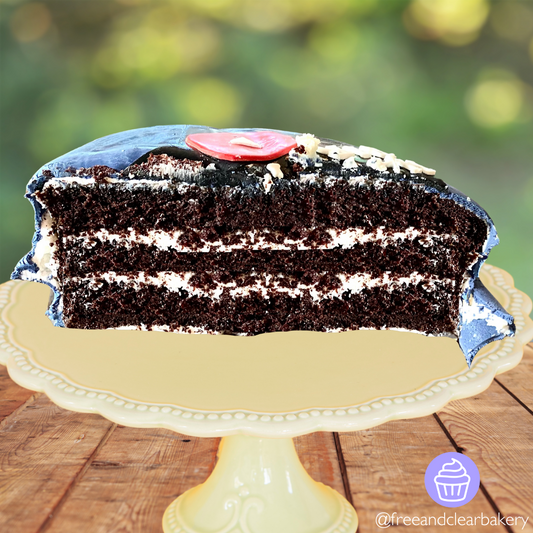 Three layers of moist chocolate cake cut in half with white frosting, covered in a dark blue fondant.