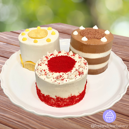 Cake Stand with three Mini Cakes on it - Red Velvet Cake in front, with Lemon Cake and Chocolate Cake behind it.