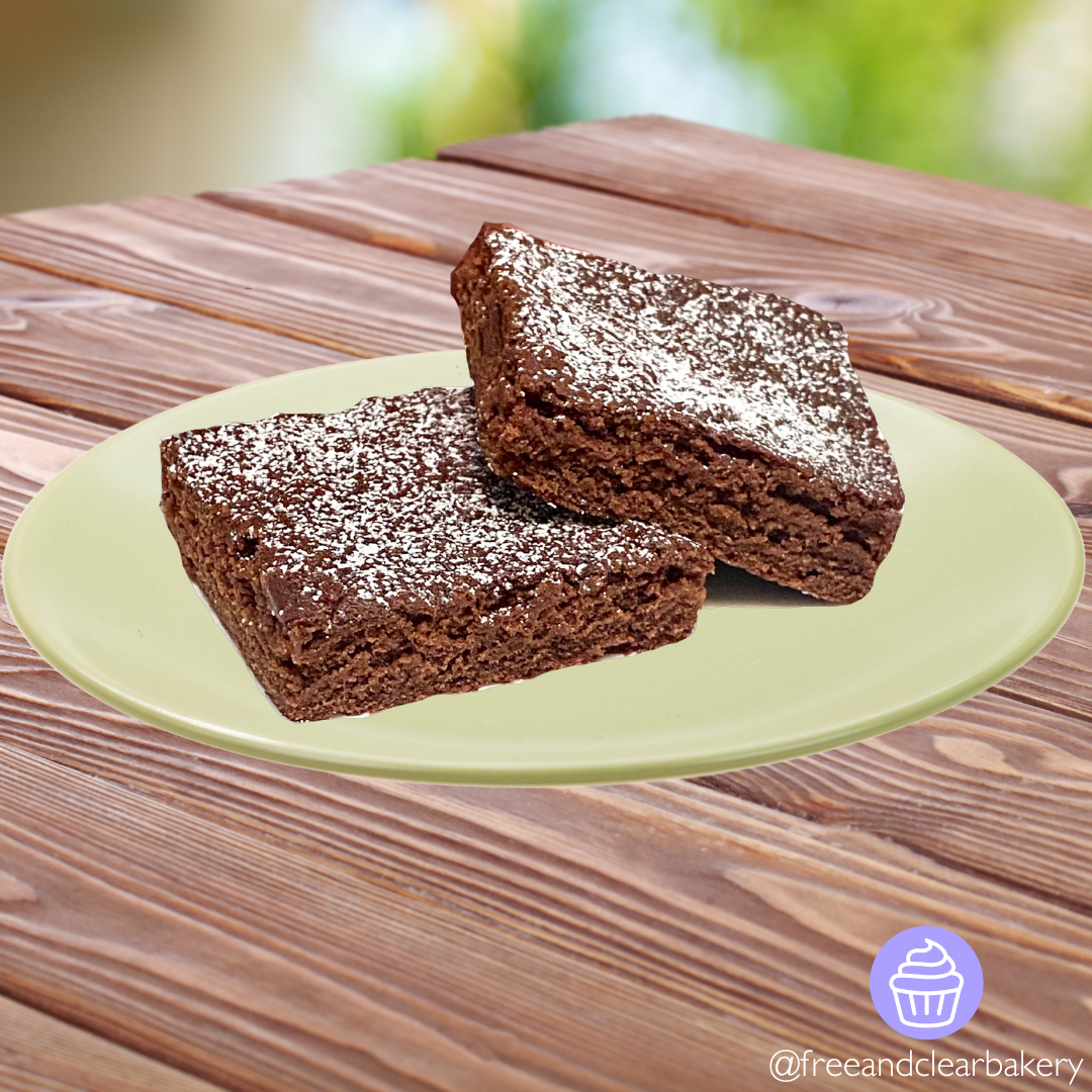 Lime green plate with two jumbo brownies lightly sprinkled with powdered sugar