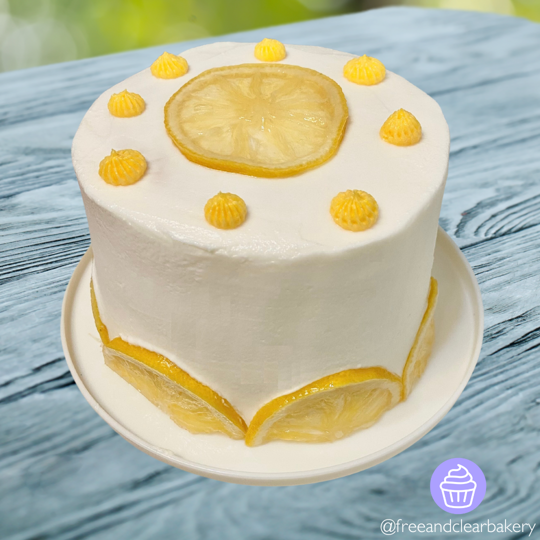 Mini Lemon Cake with White Frosting, Candied Lemon Slices, and Yellow Frosting Dollops